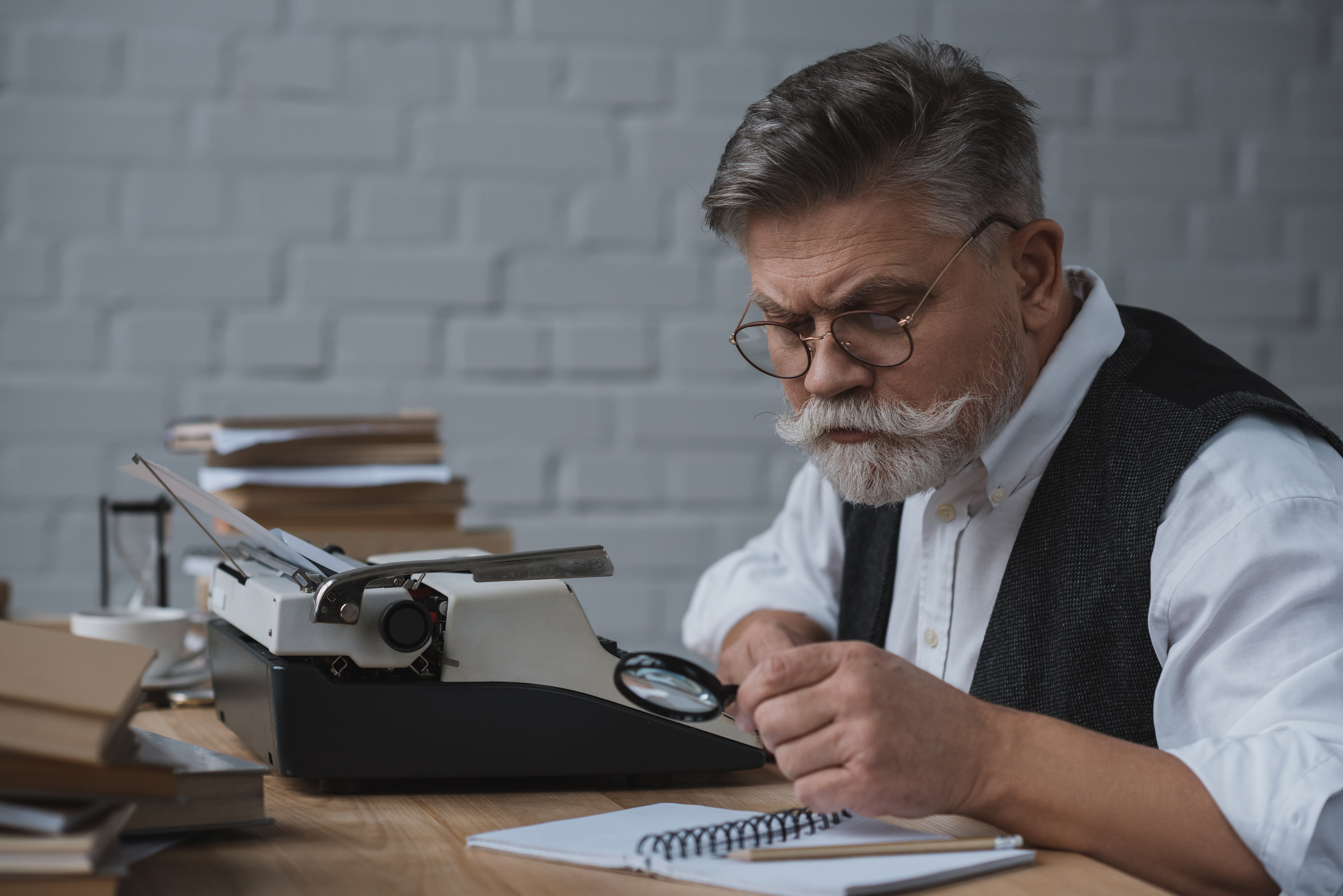 senior writer rewriting manuscript with typing machine