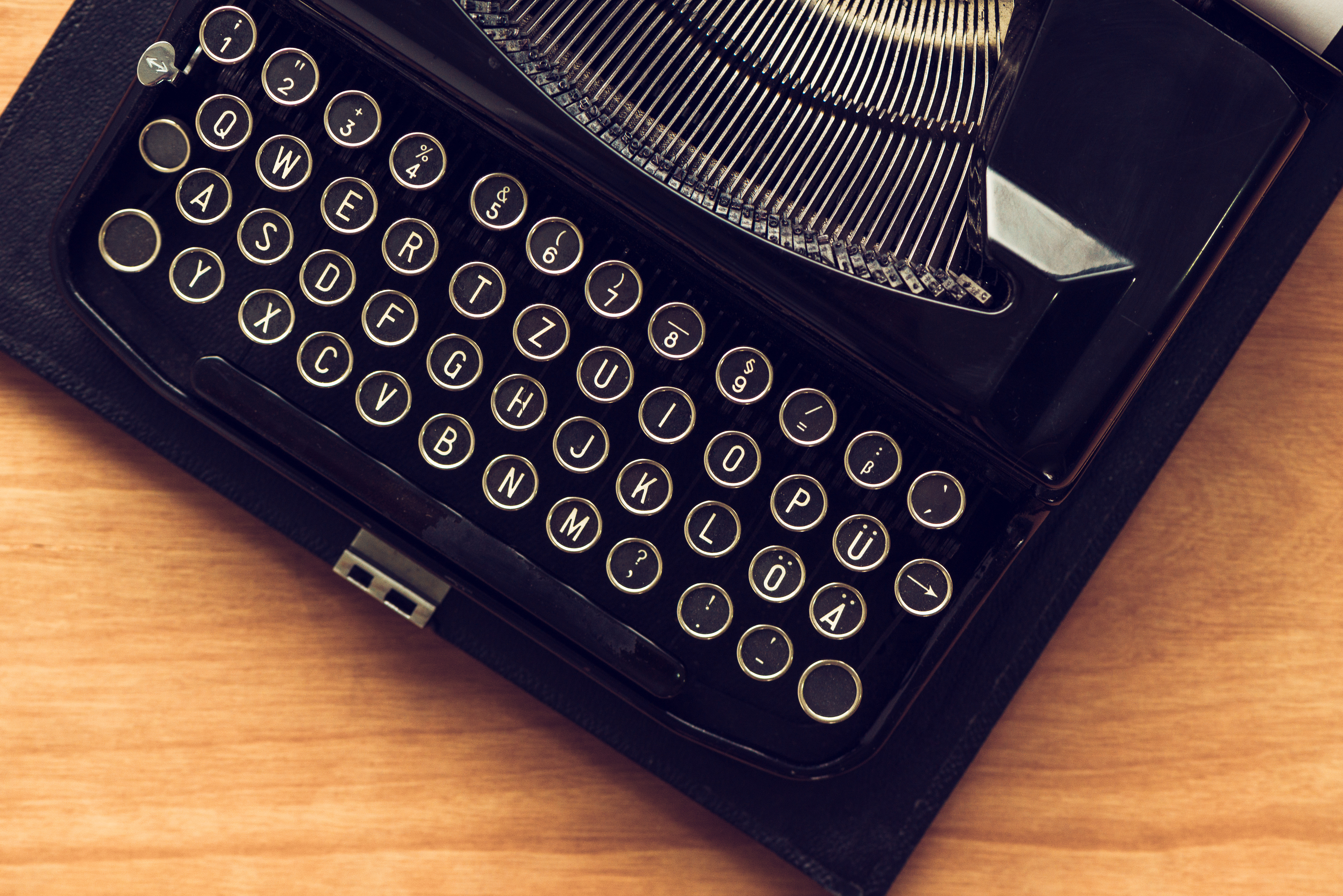 Vintage typewriter machine on writers desk, top view flat lay conceptual image for blogging, publishing, journalism or poetry writing.